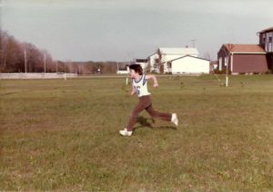 Child running on a grassy field.