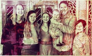 Family posing together in stylized photograph.